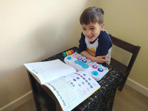 Jaxon plays with a Soundbops device.