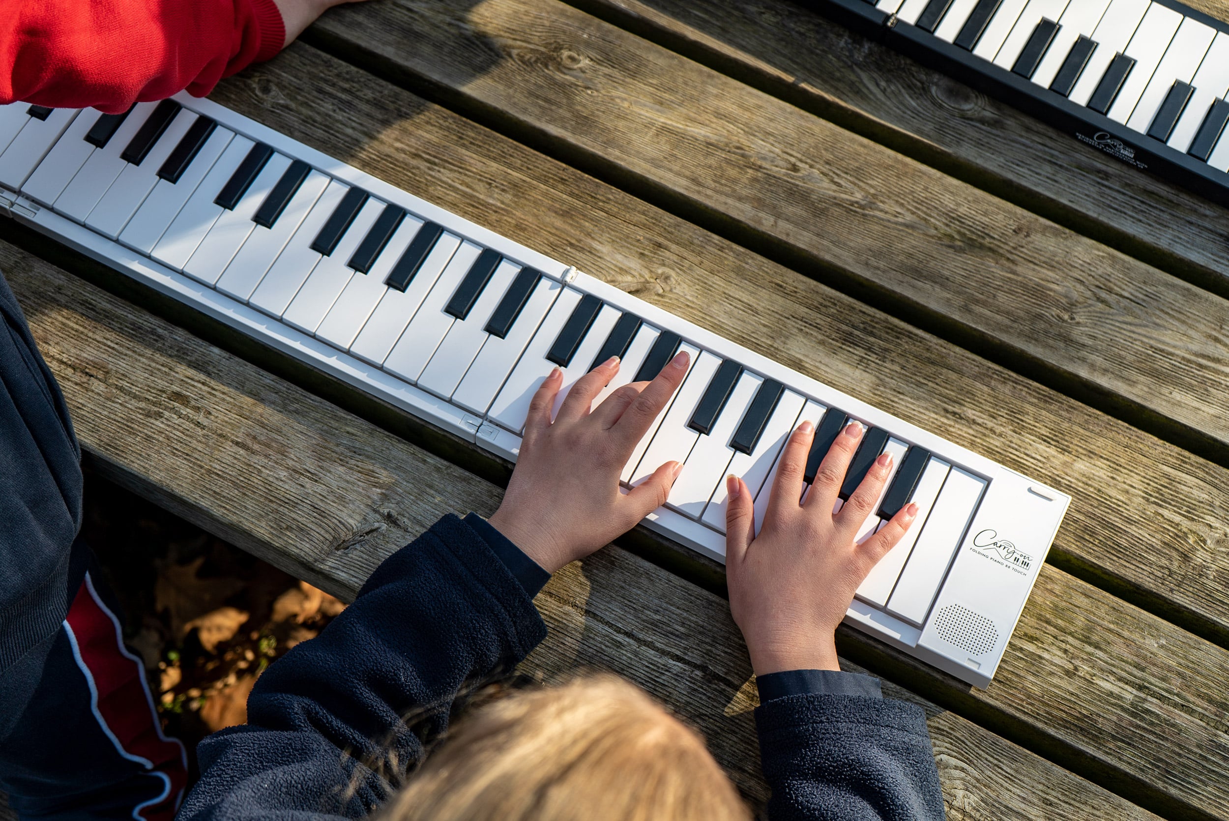 A child playing the Carry-on folding piano.