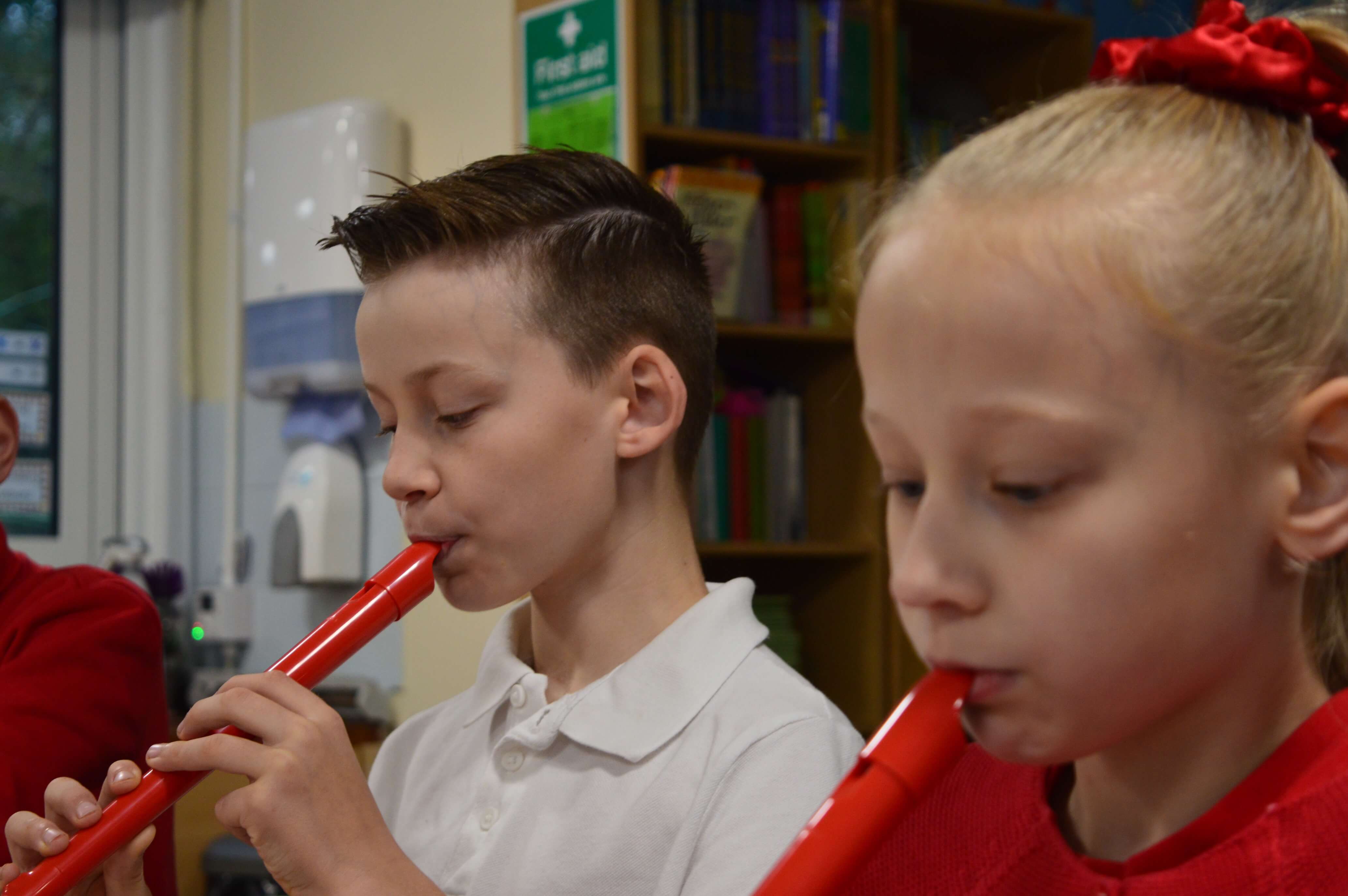 Kids in classroom play the pCorder.