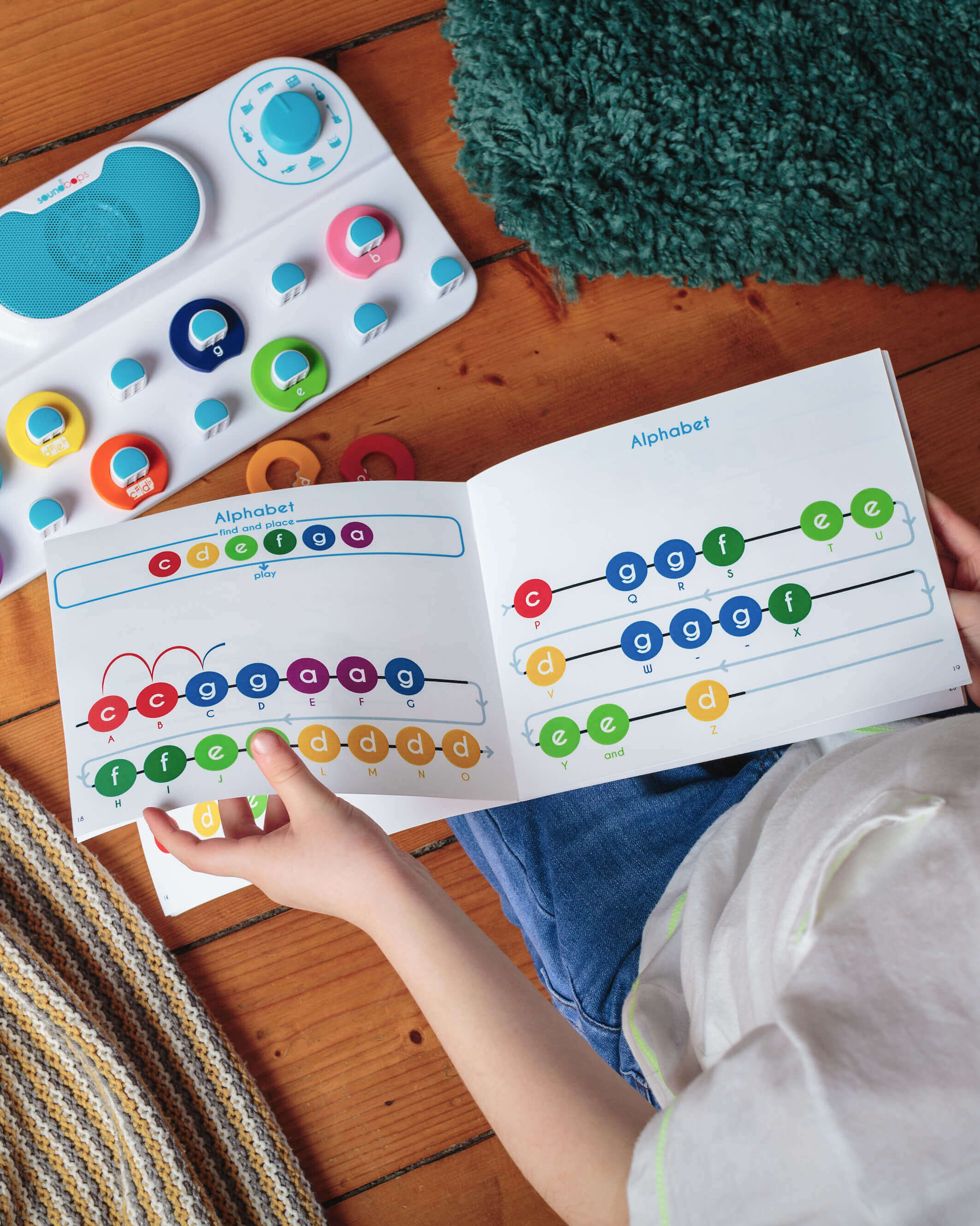 A child reading a musical book from Soundbops.