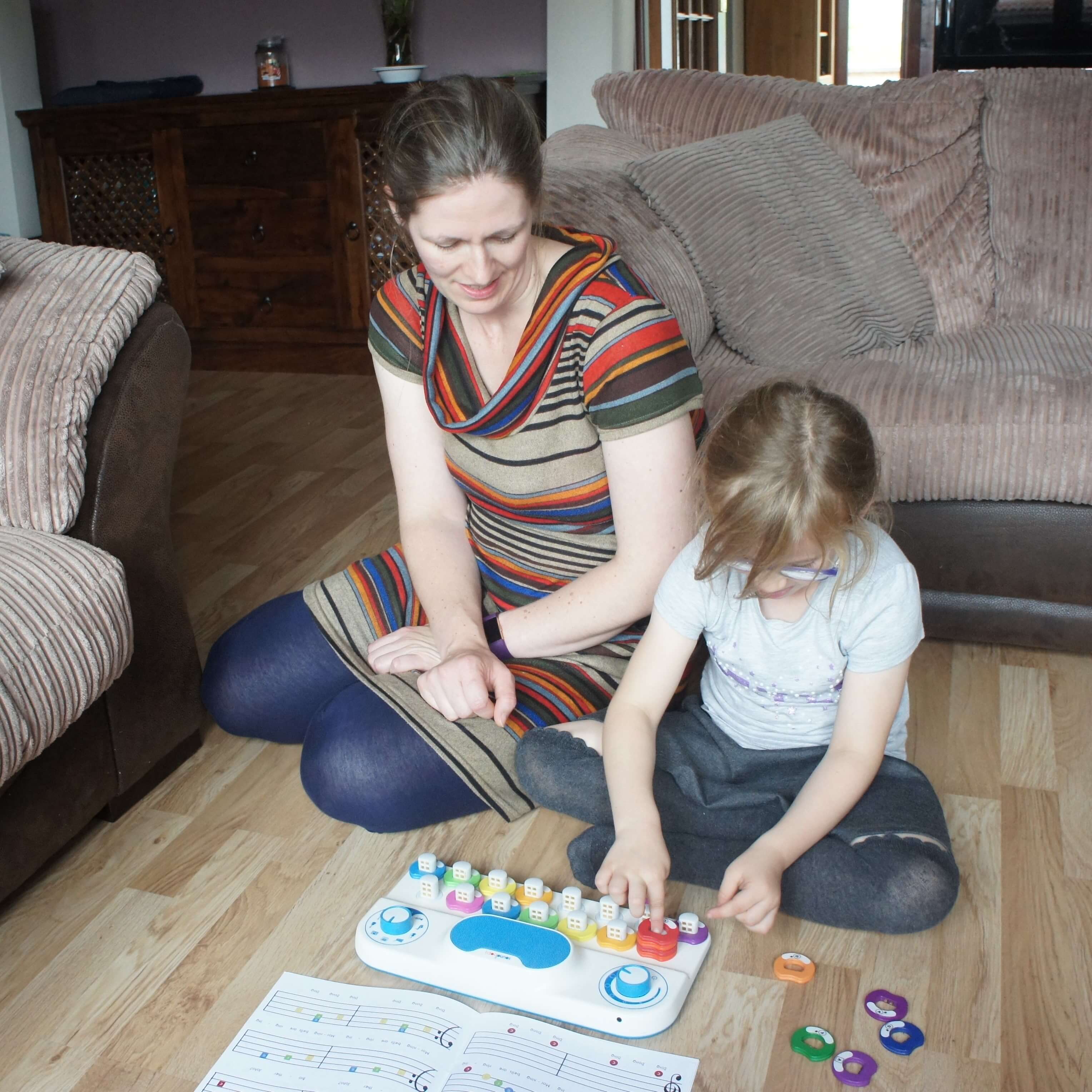Child and parent playing with a Soundbops instrument