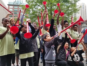 Children hold their pBuzz instruments.