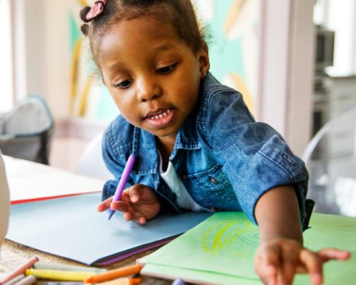A child with crayons.