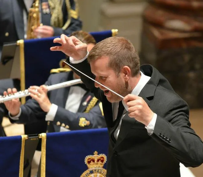 Steven Legge conducting an orchestra.