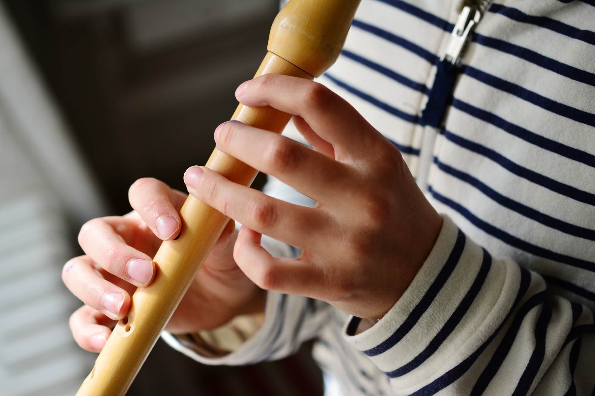 Child playing a recorder.